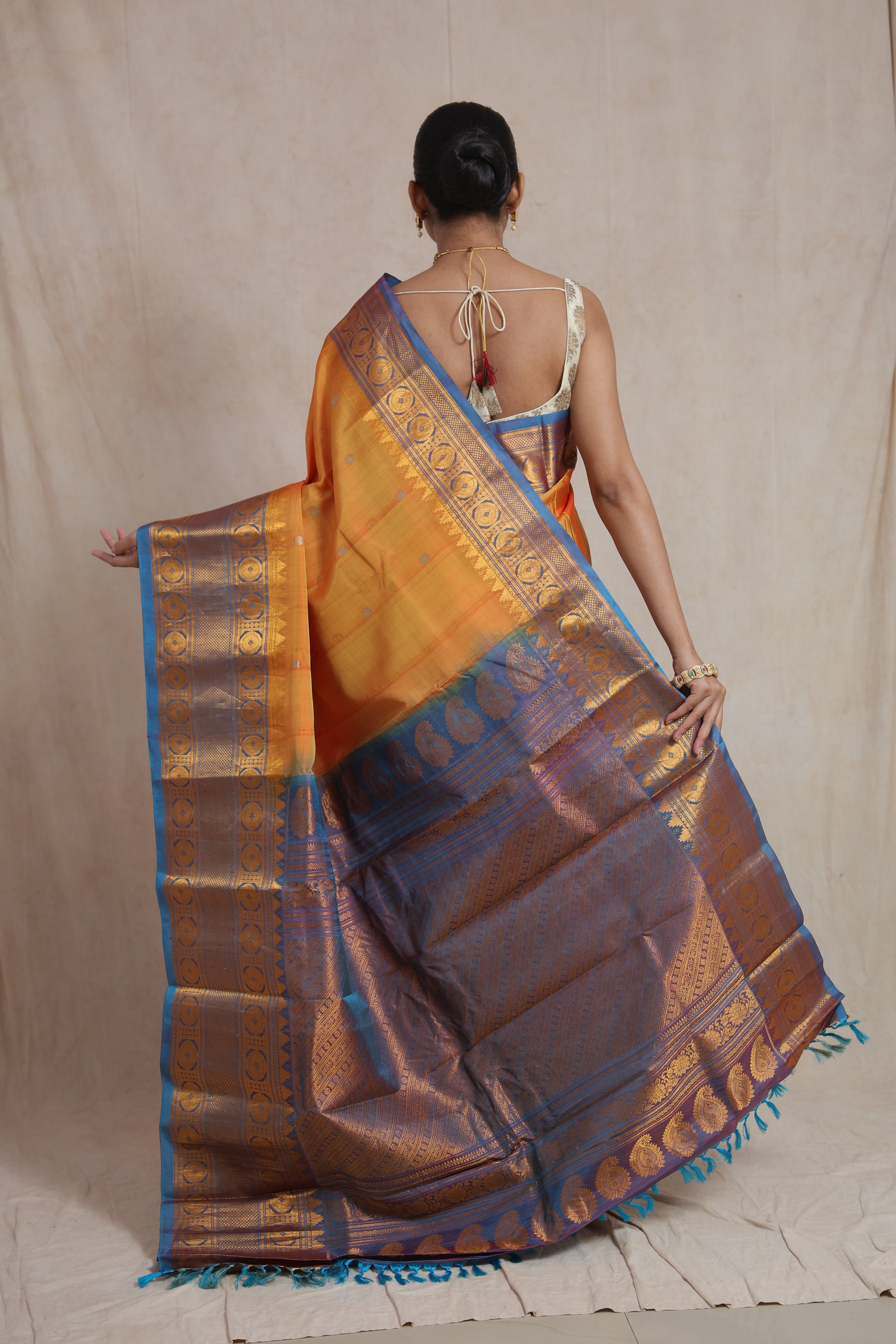Back view of orange Gadwal silk saree with rich royal blue pallu