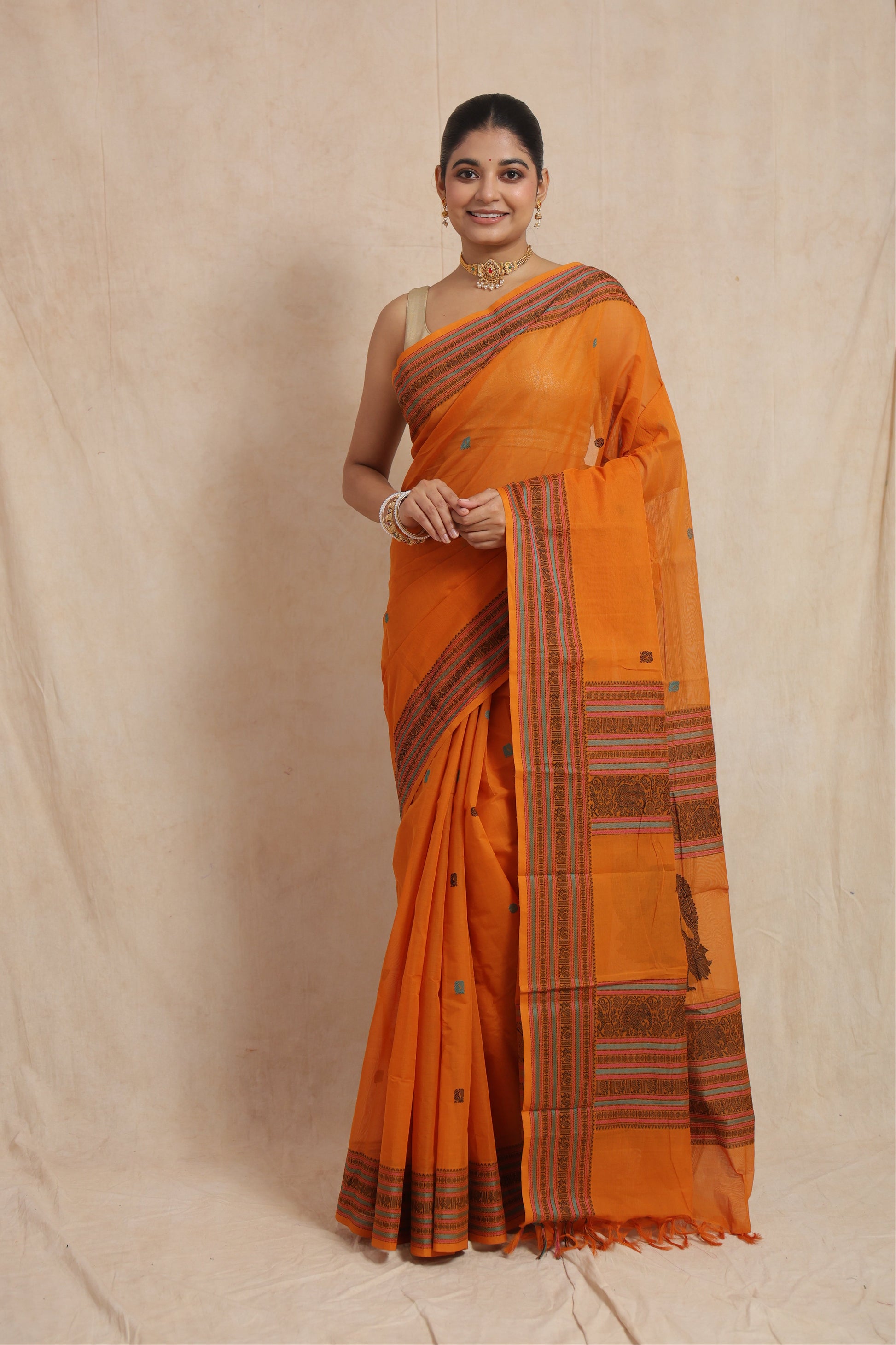 Sunset orange Kanchipuram handloom cotton saree with woven buttas and traditional border