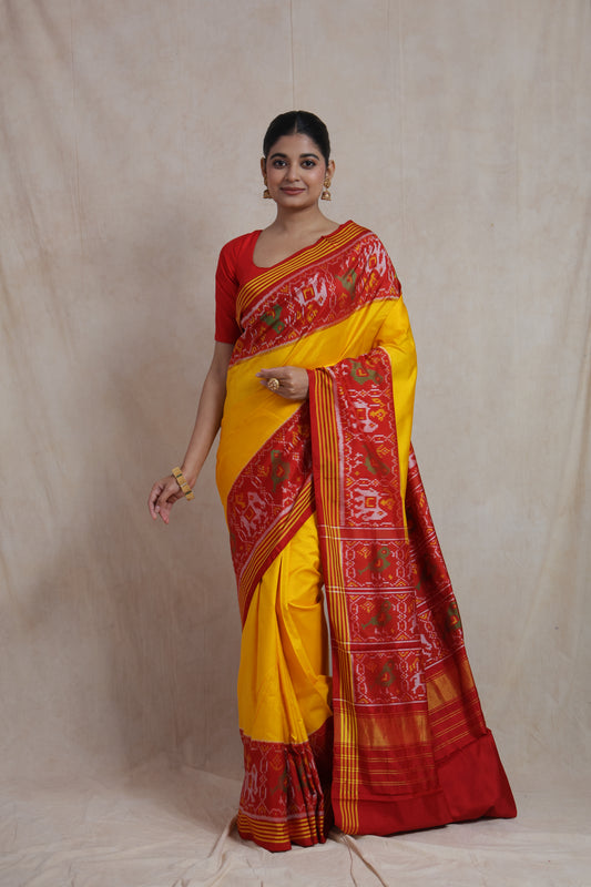 Full-length view of sunshine yellow Patola handloom silk saree with vibrant red patterned border