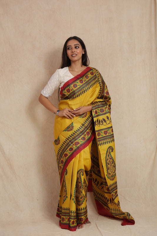 Front drape view of sunshine yellow printed Tussar saree with paisley prints