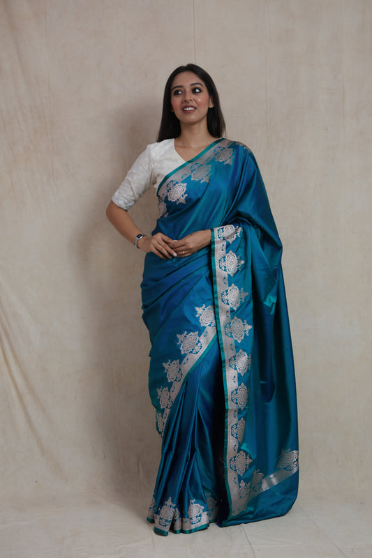 Teal blue Banarasi art silk saree with silver zari floral woven border