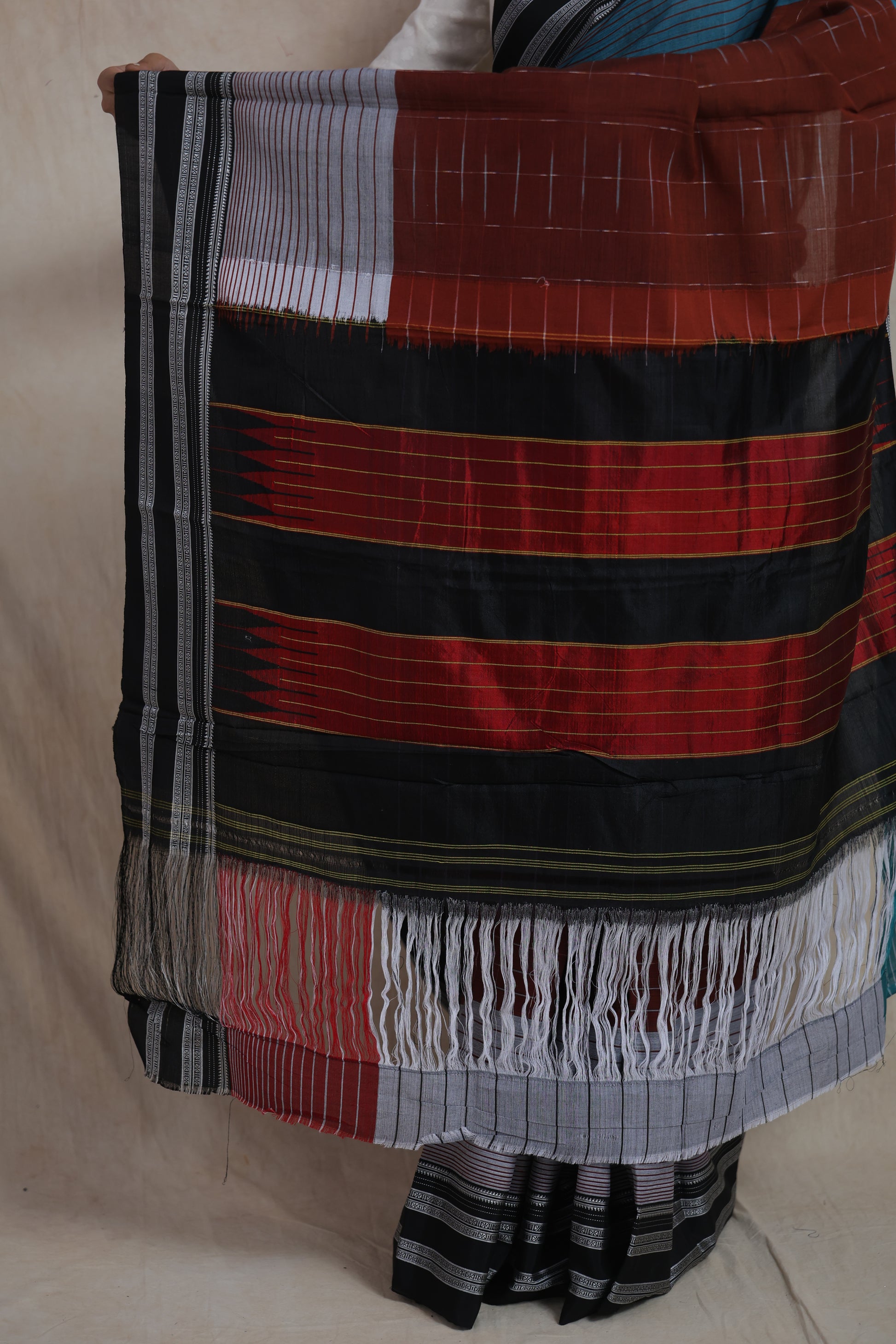 Side profile of rust brown and teal Ilak cotton saree with contrast woven pallu