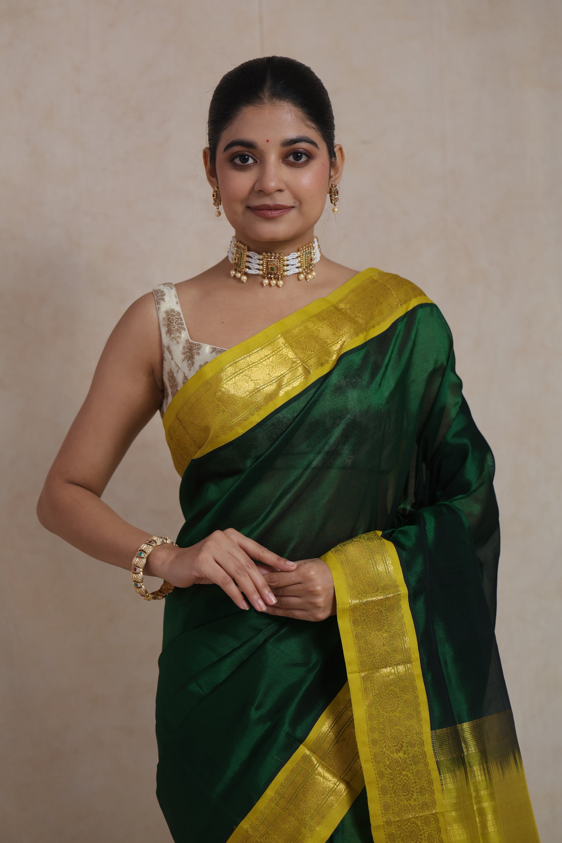 Full standing pose in emerald green Kanchipuram silk cotton saree