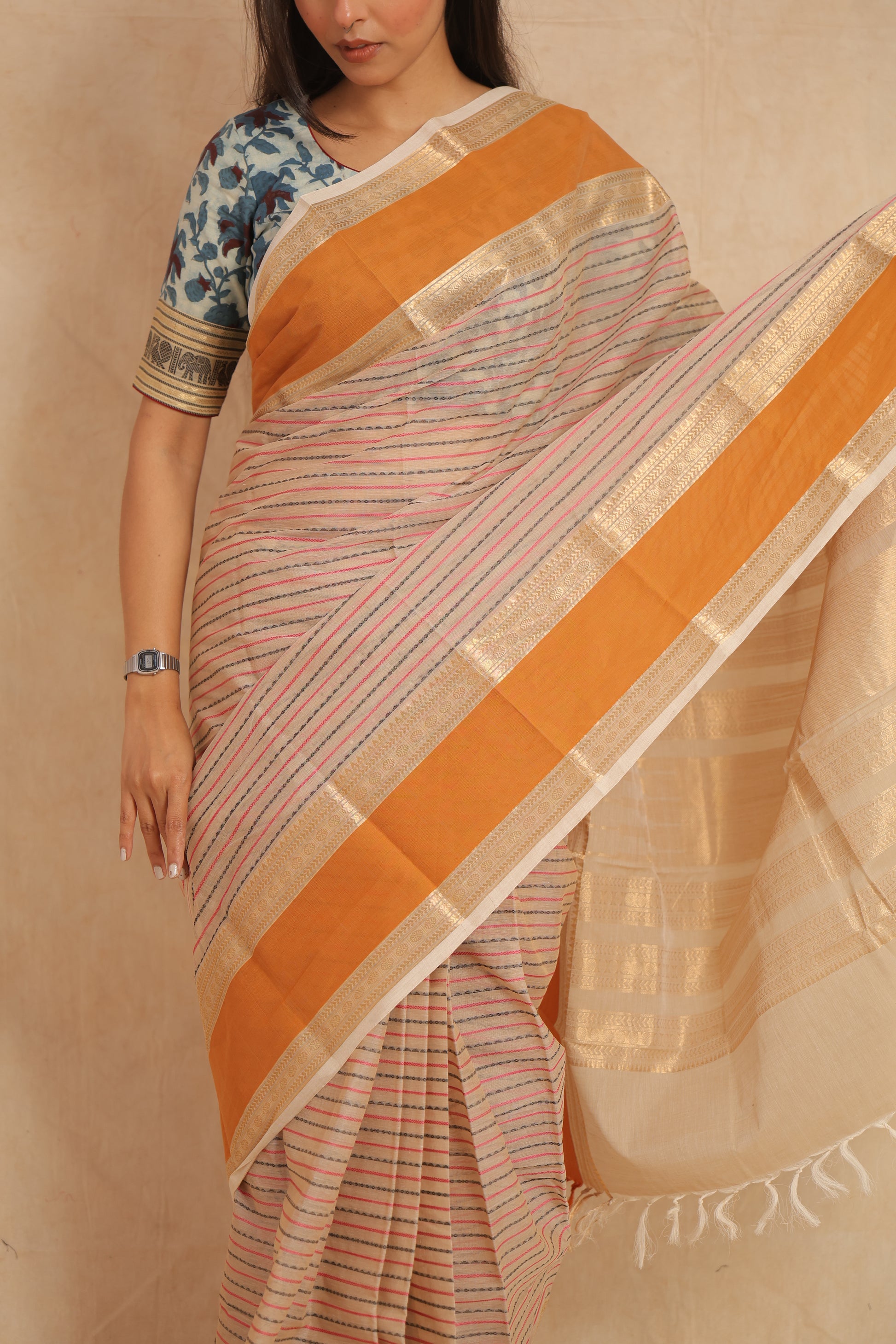 Traditional Kanchipuram cotton saree drape with elegant orange border