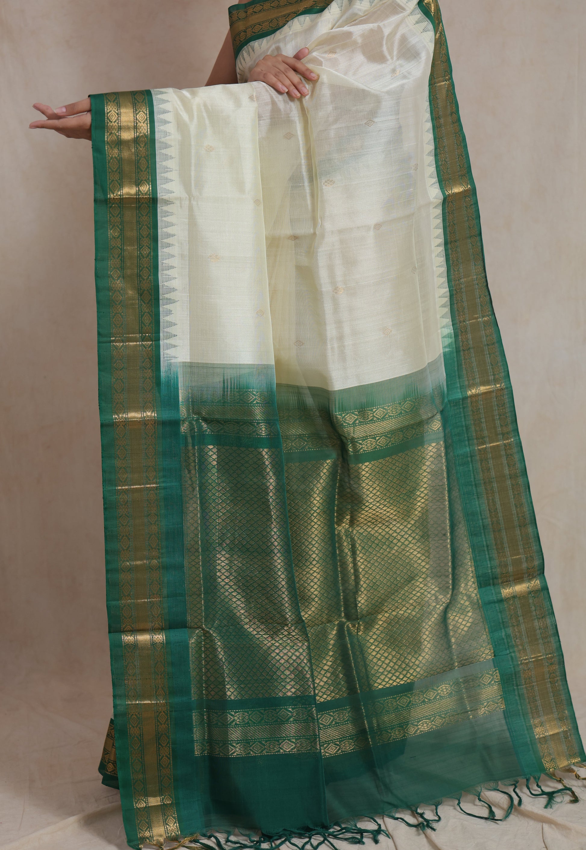Traditional ivory silk cotton saree with green woven pallu