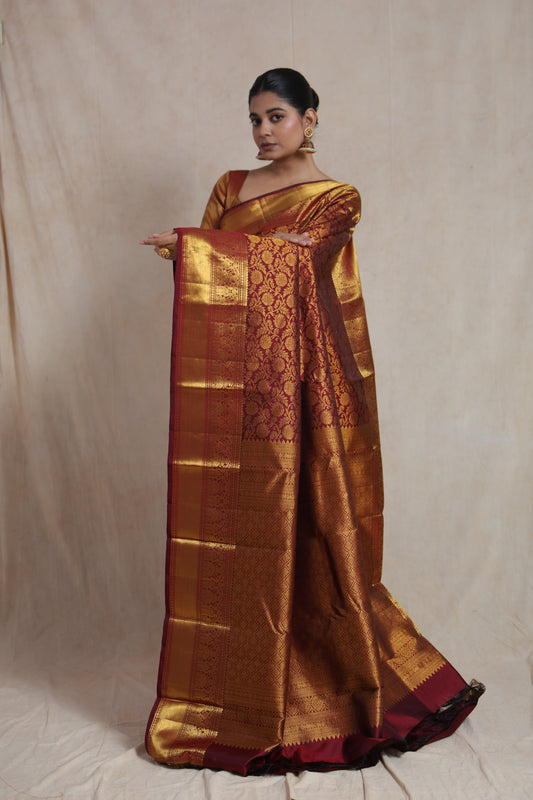Full display of traditional maroon Kanjivaram silk saree with grand zari border