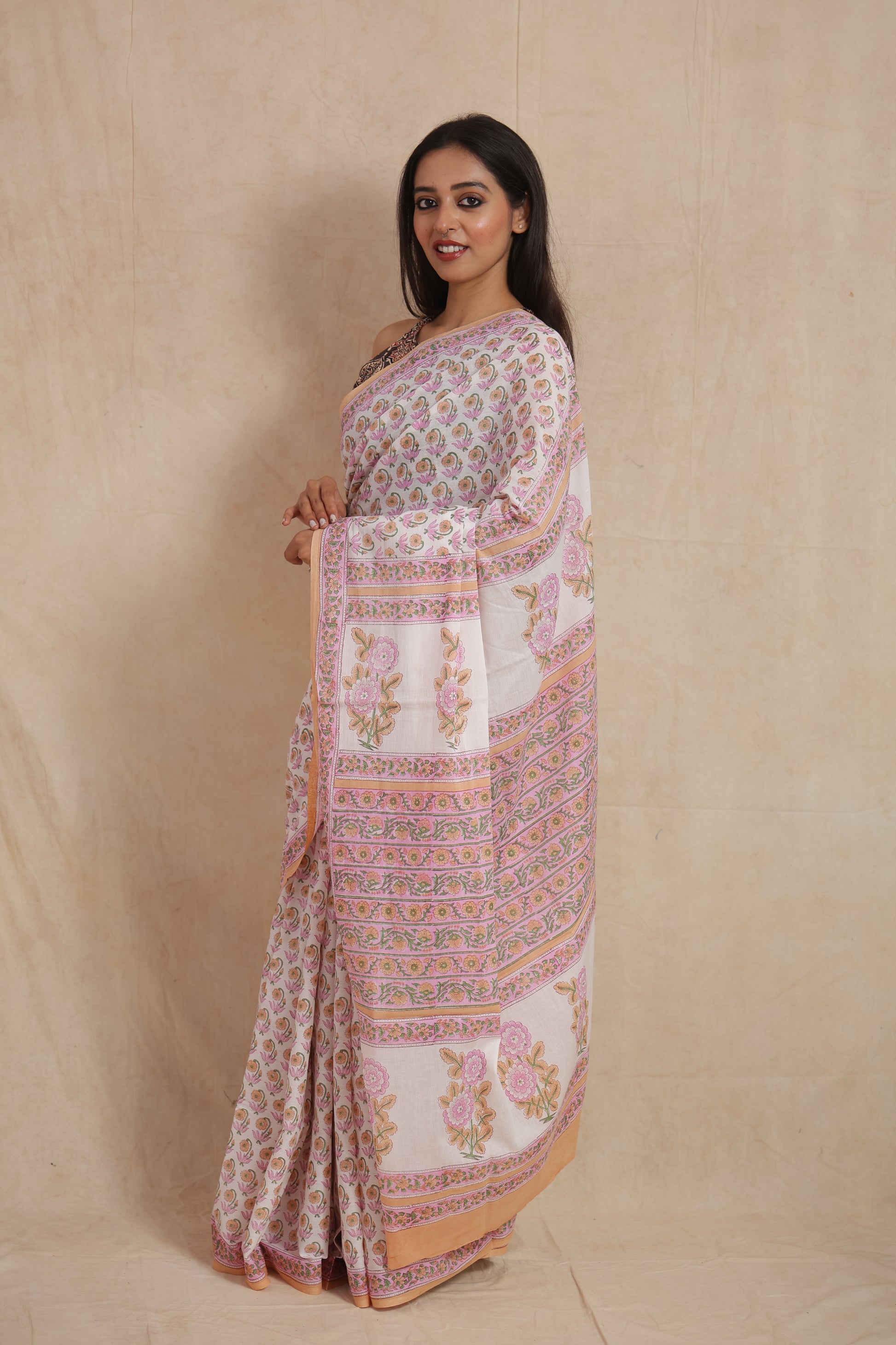 Side view of traditional pastel pink Sanganeri cotton saree