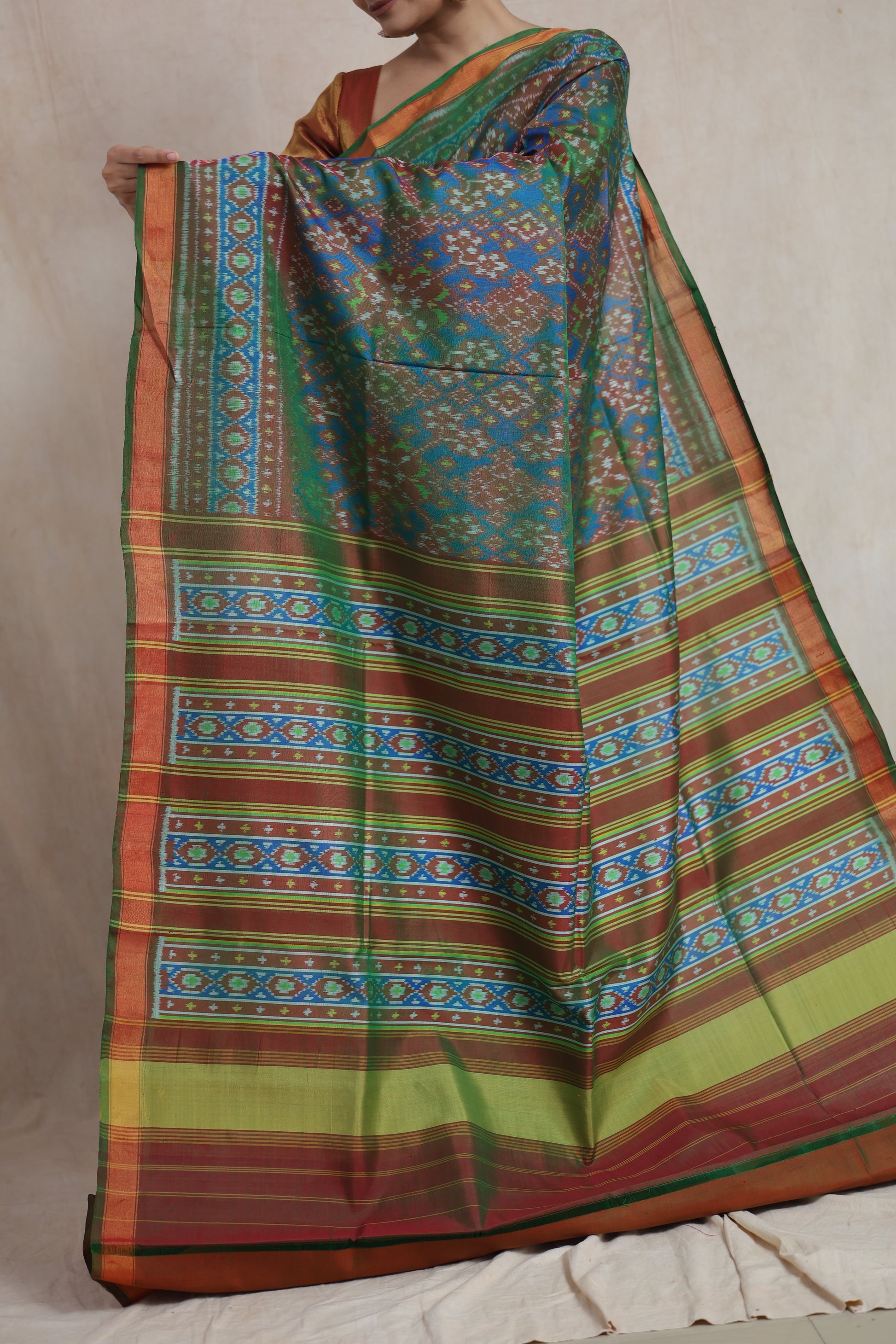 Traditional Patola handloom silk saree pallu with intricate geometric borders and heritage weaving