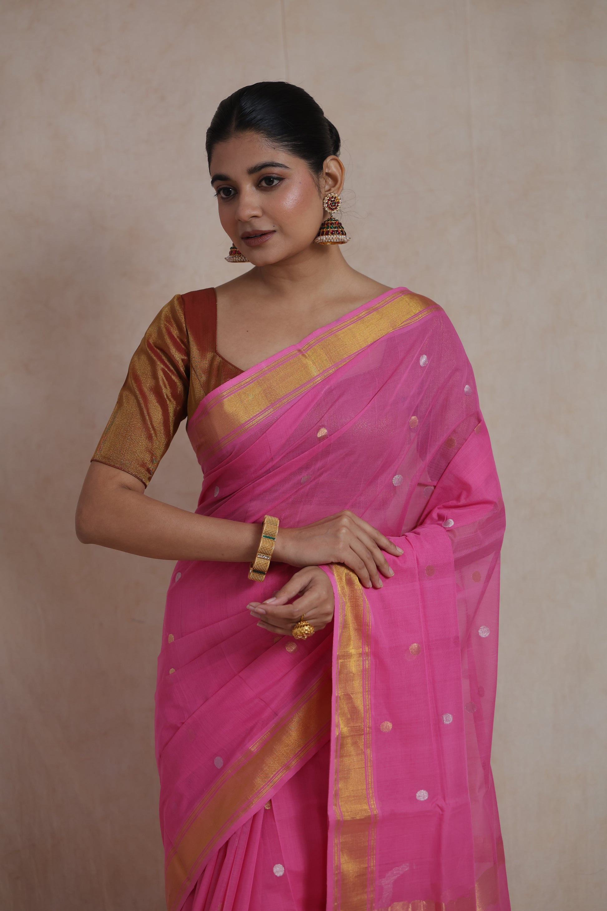 Portrait view of pink Kanchipuram cotton saree with zari border
