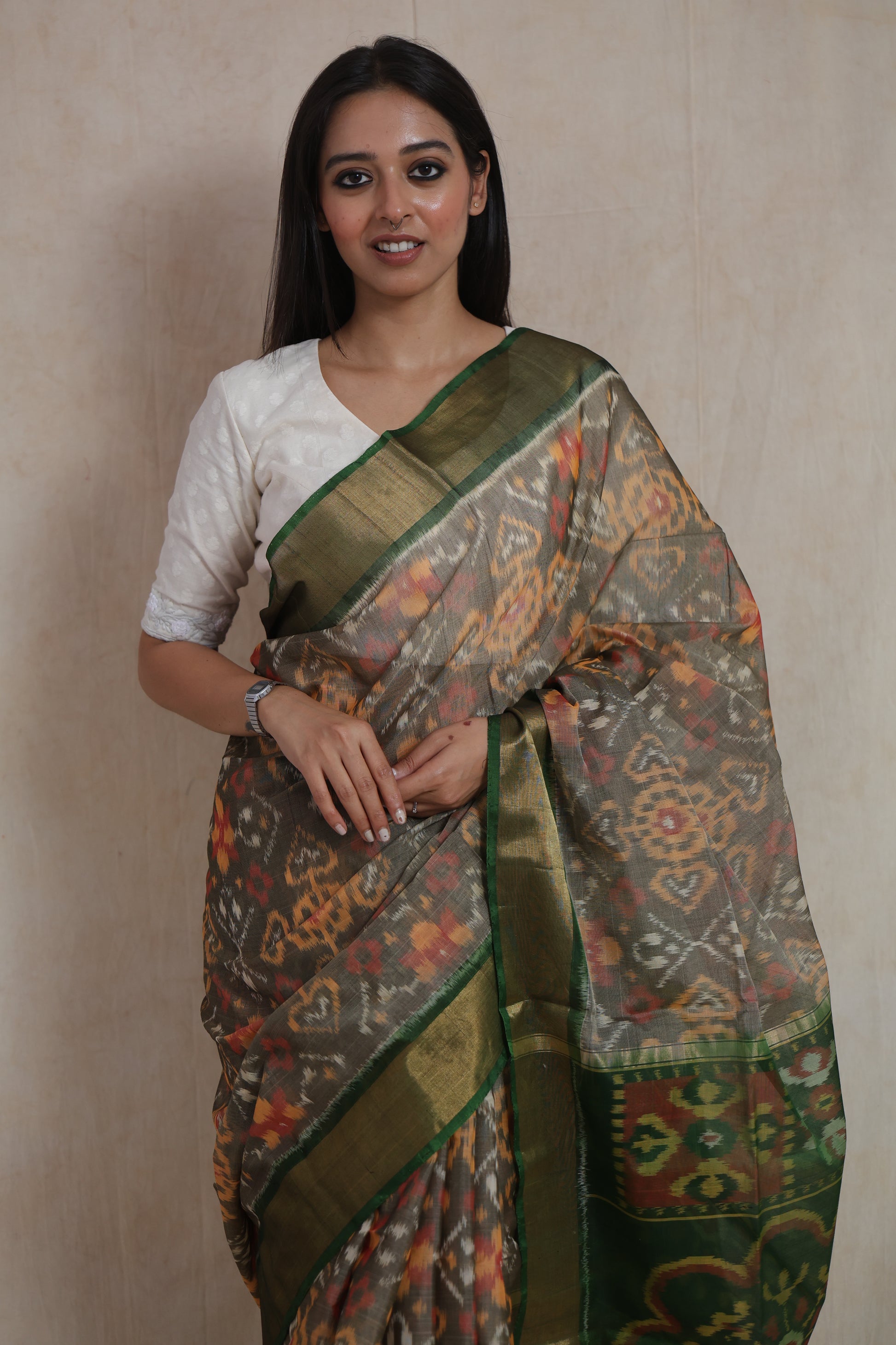 Full-length view of traditional Panchampali handloom silk cotton saree in taupe grey and emerald green combination with tassels