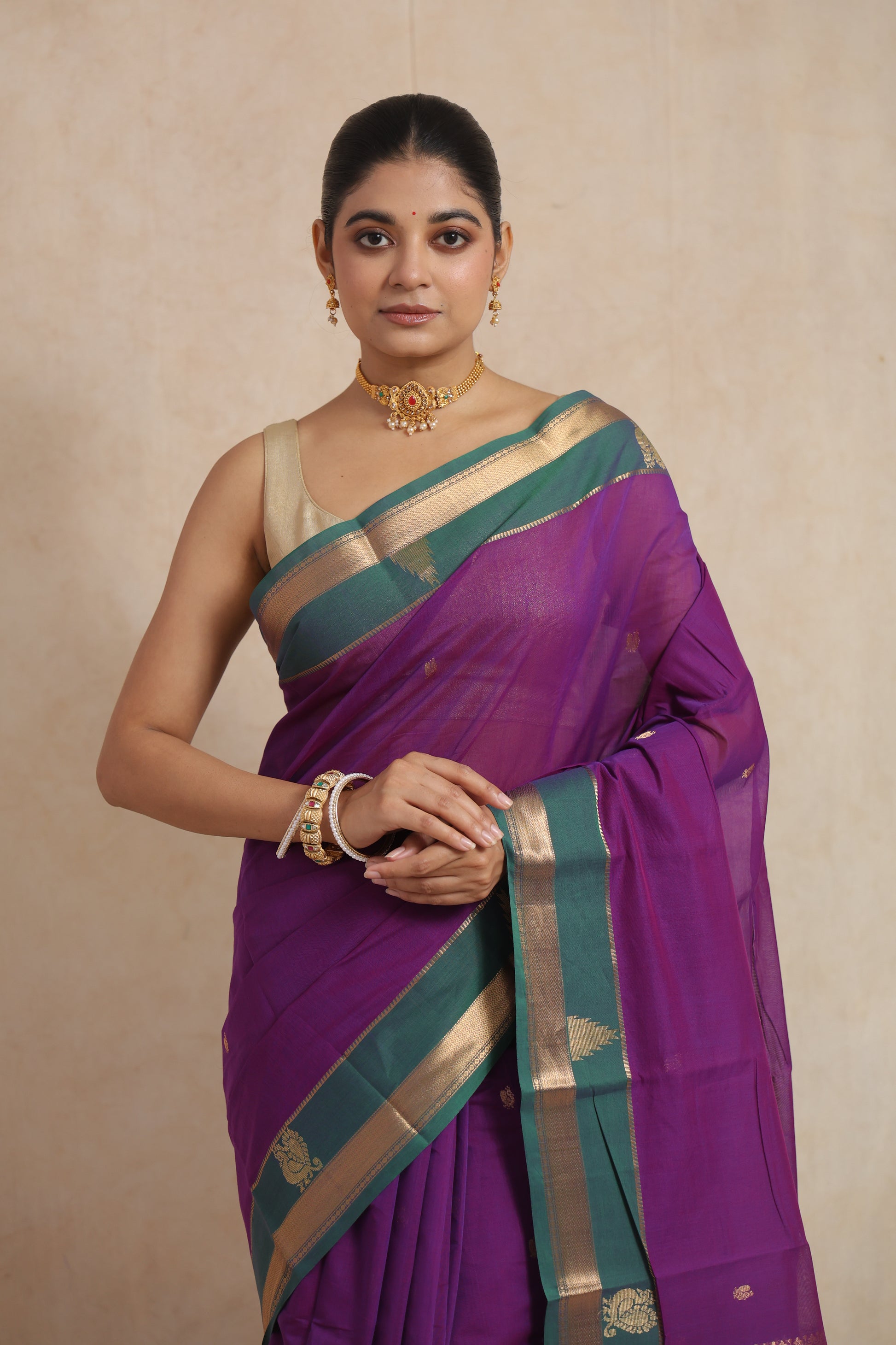 Detailed view of royal purple cotton saree showcasing woven buttas and traditional border patterns