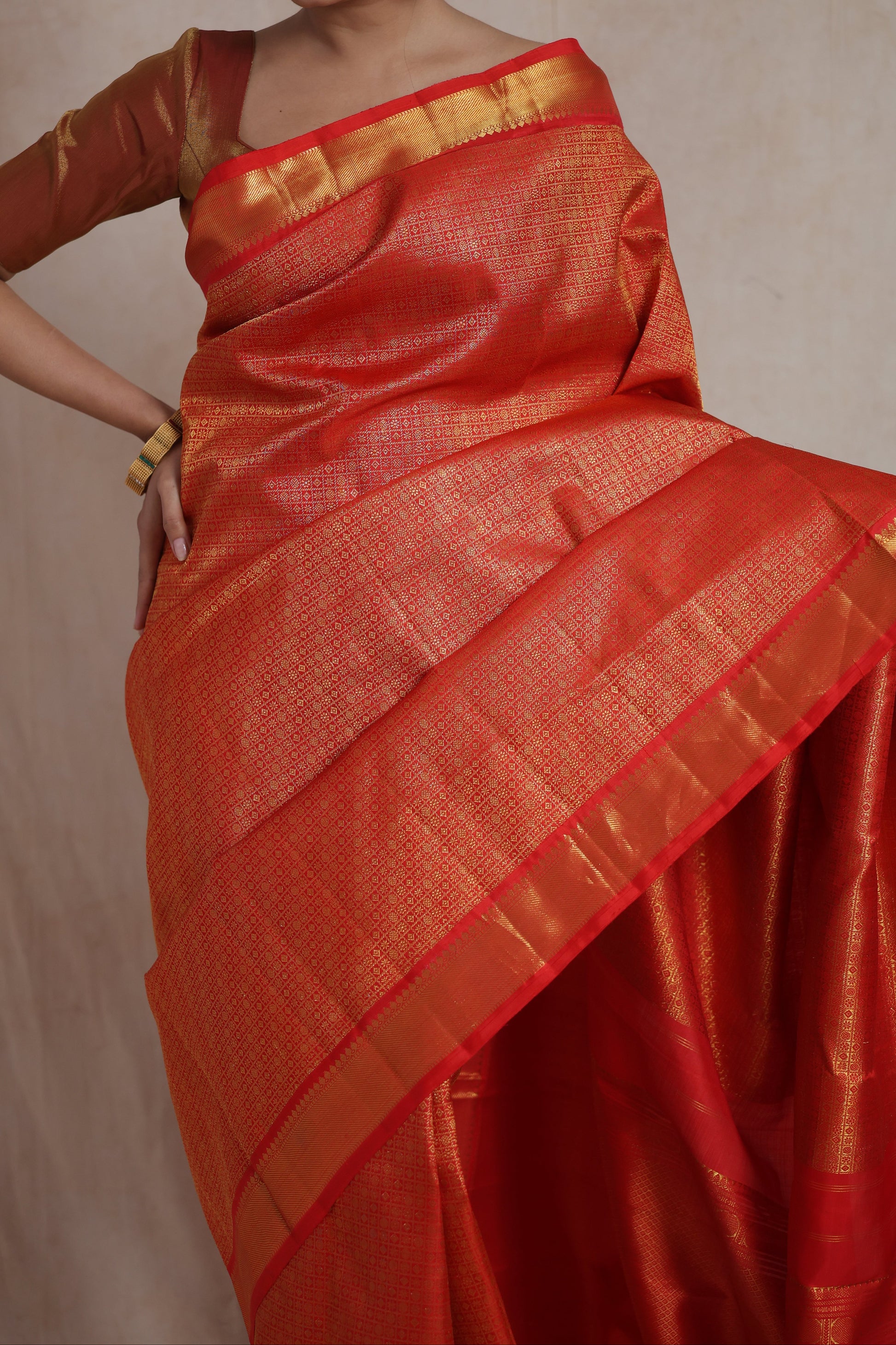 Detailed view of woven border and intricate craftsmanship on vermilion red Kanjivaram silk saree