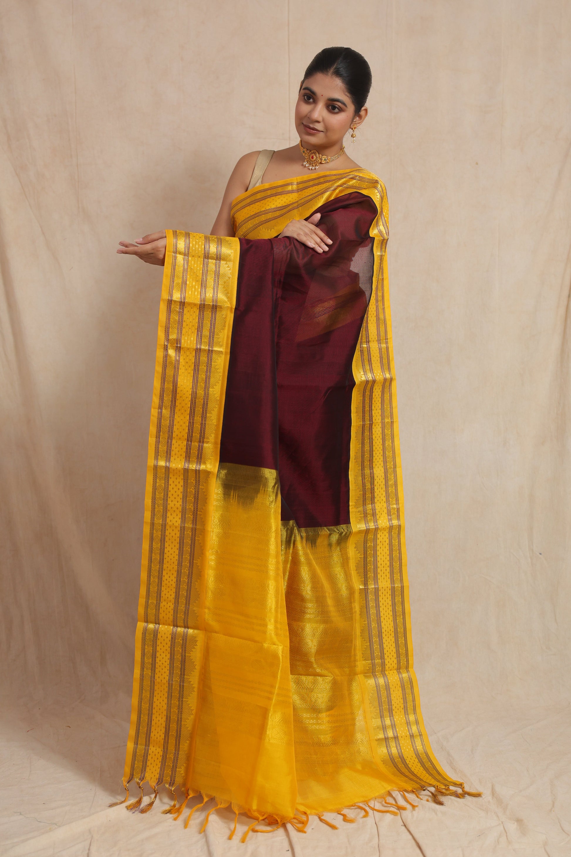 Detailed display of the golden yellow pallu with traditional woven motifs on Kanchipuram Handloom SICO saree
