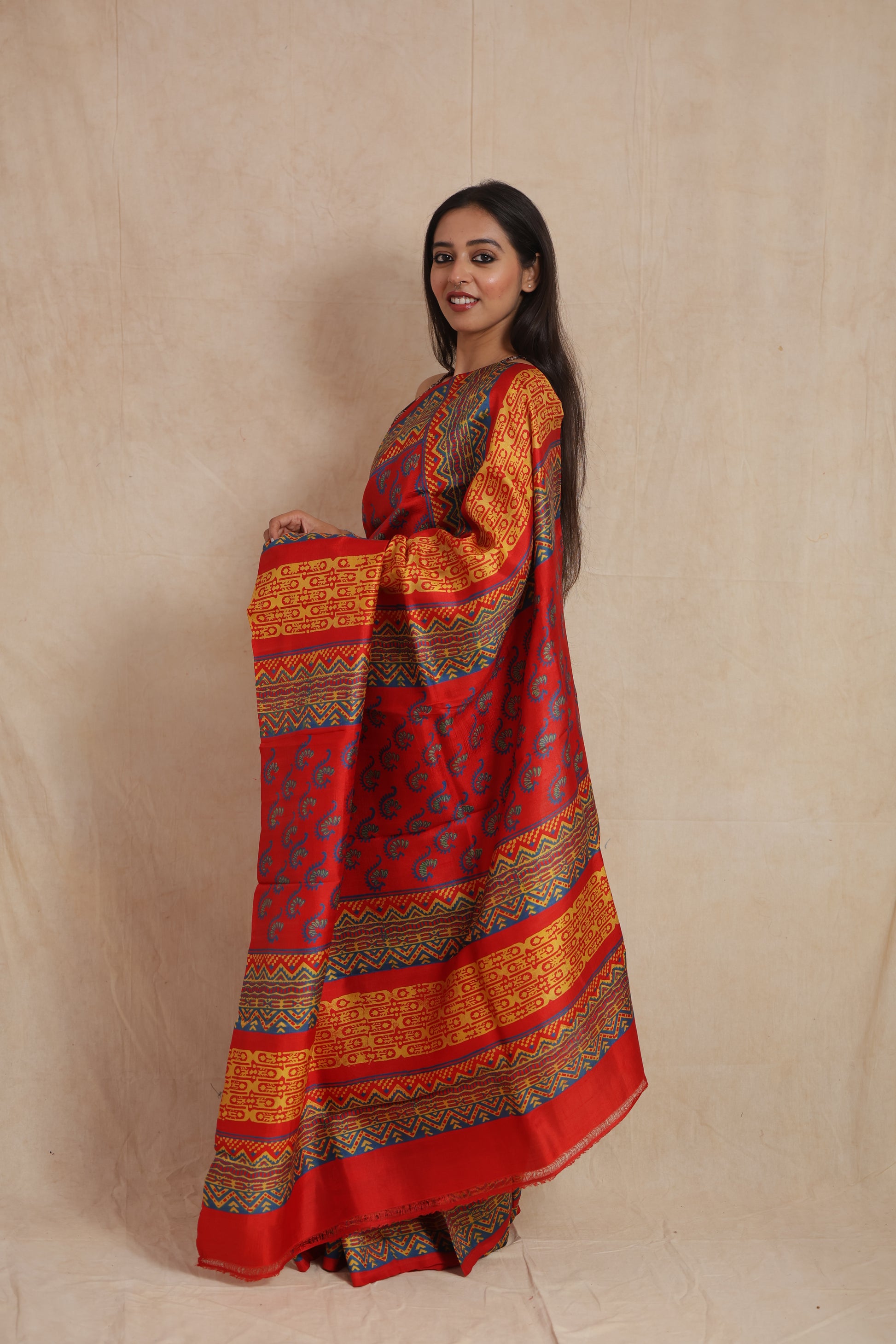 Side profile of royal red Batik silk saree with vibrant ethnic border detailing