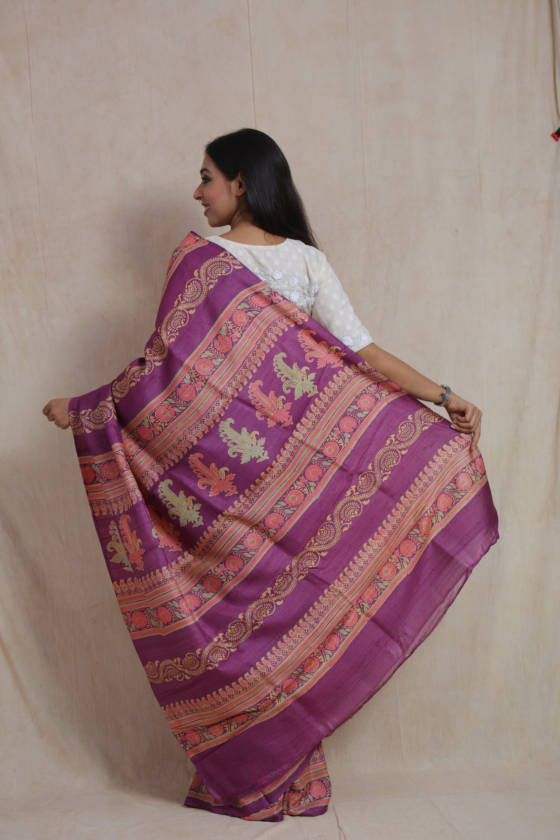 Back pallu display of purple Tussar Batik print saree with floral detailing
