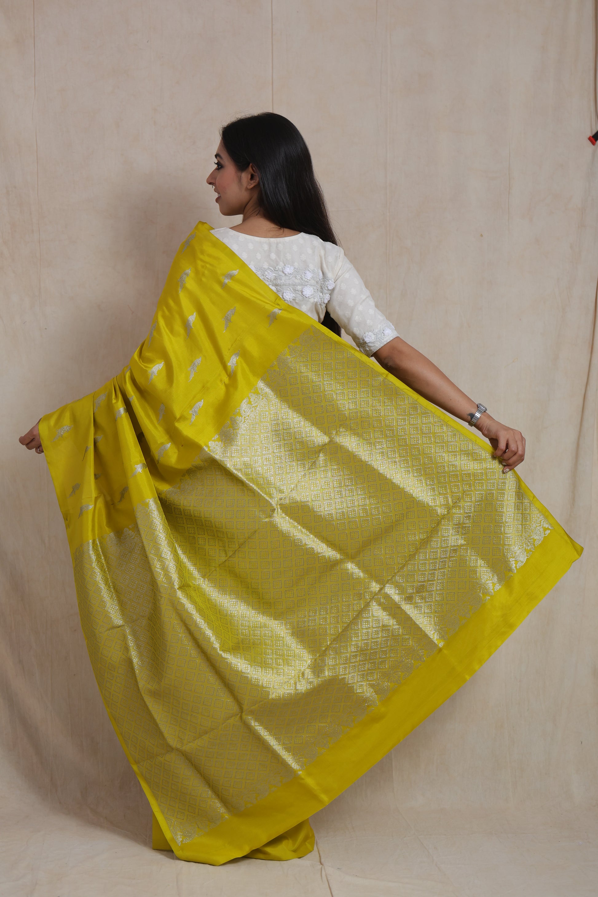 Back view of sunshine yellow Venkatgiri saree with detailed woven pallu
