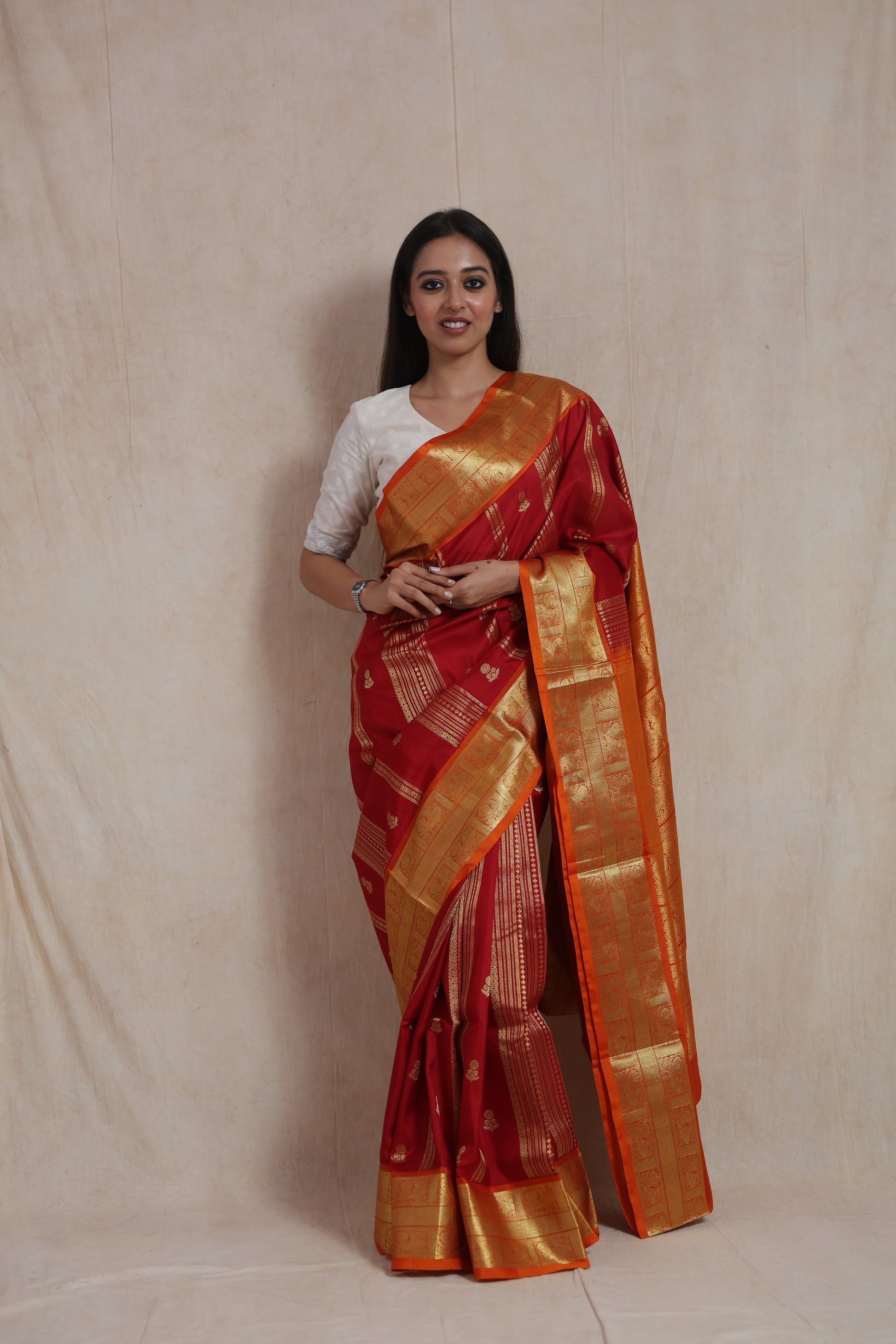 Full-length view of crimson and orange Venkatgiri handloom silk saree with traditional motifs