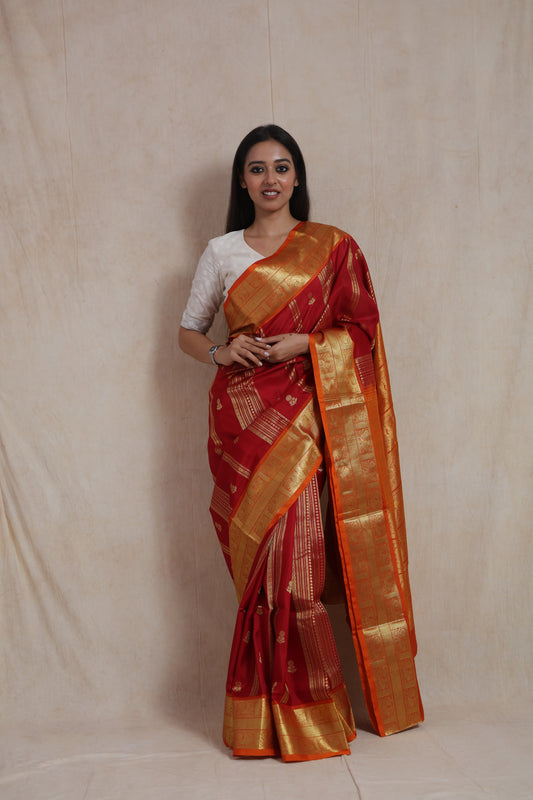Full-length view of crimson and orange Venkatgiri handloom silk saree with traditional motifs