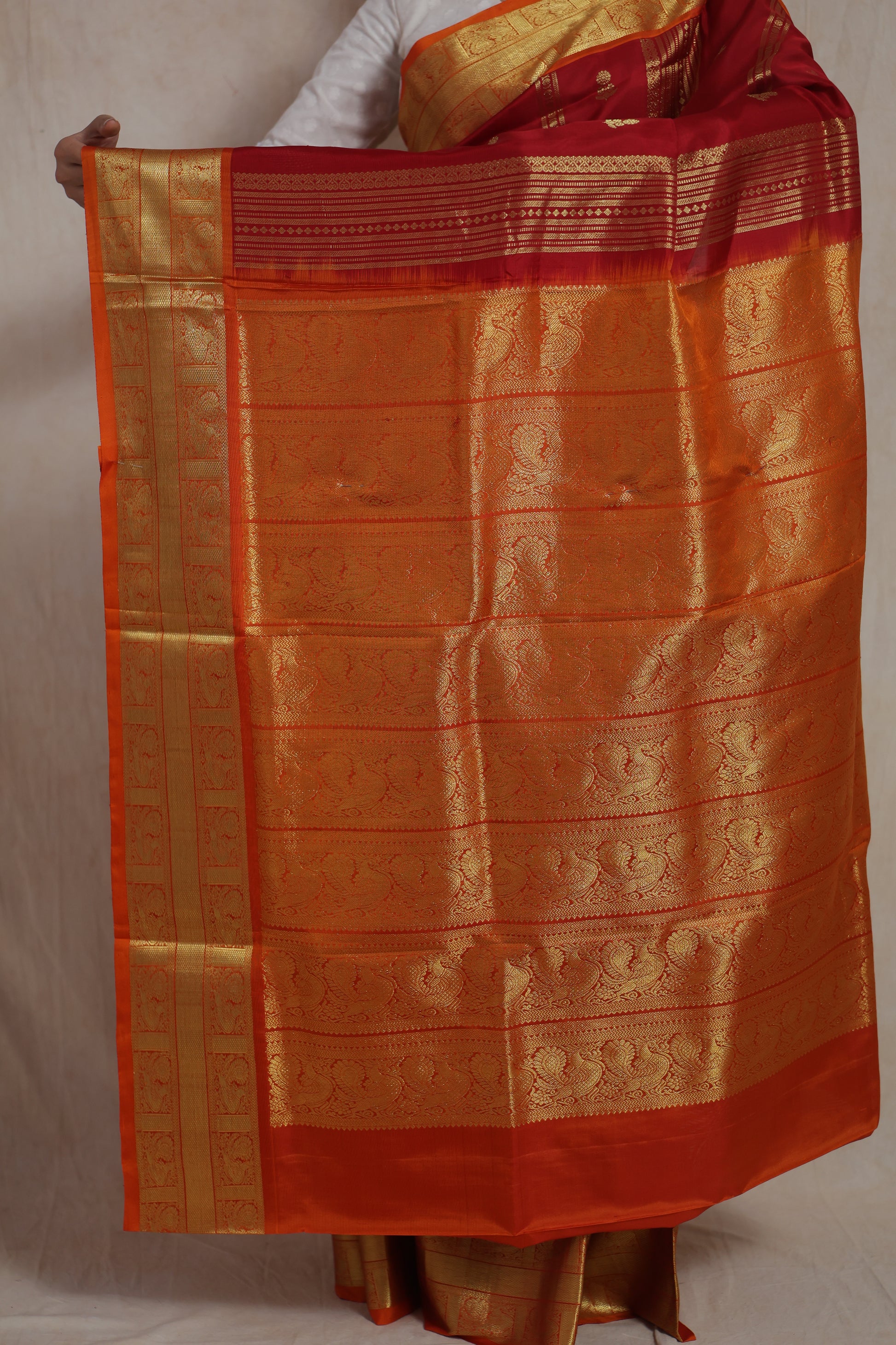 Detailed view of woven orange pallu and traditional border on Venkatgiri silk saree