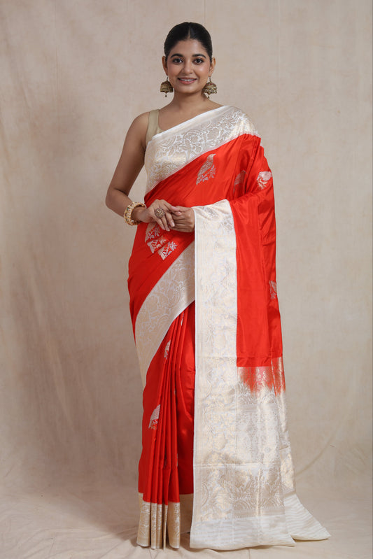Front view of vermilion Banarsee silk saree with silver zari bird prints