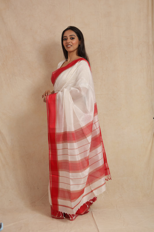 Side profile of ivory white Maheshwari silk saree with striped red pallu