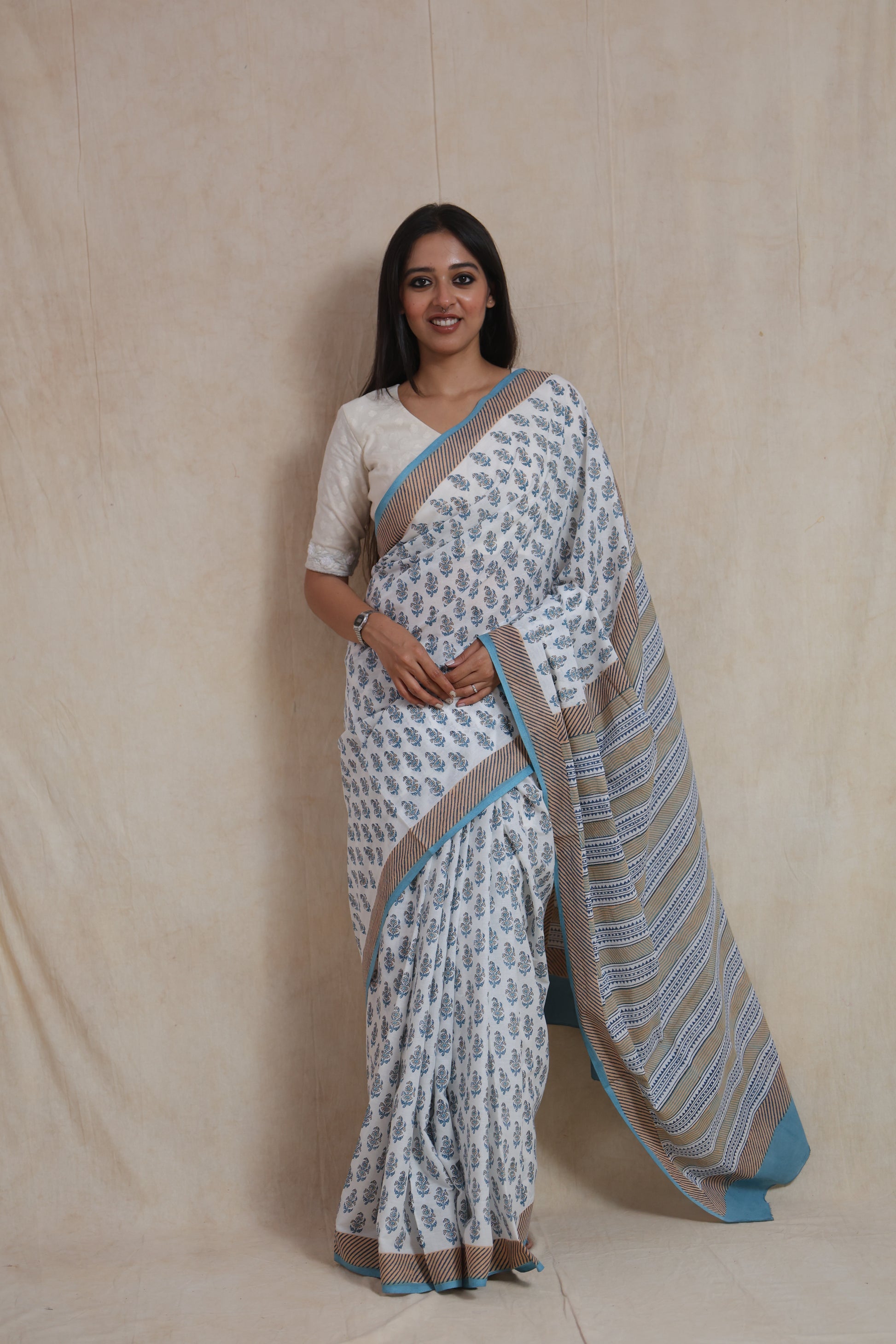 Full look of white and blue Sanghnaree cotton saree with traditional prints