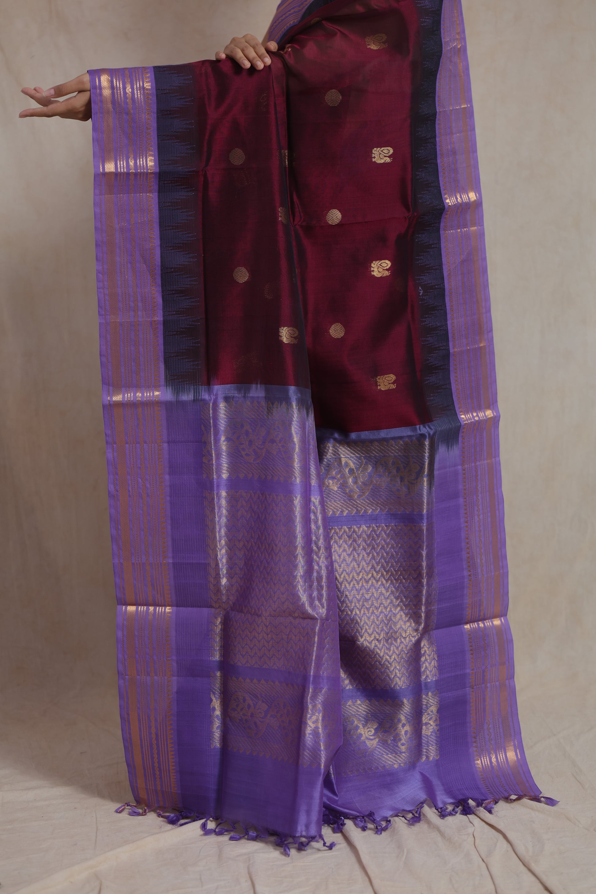Close-up of wine purple silk cotton saree with golden zari buttas