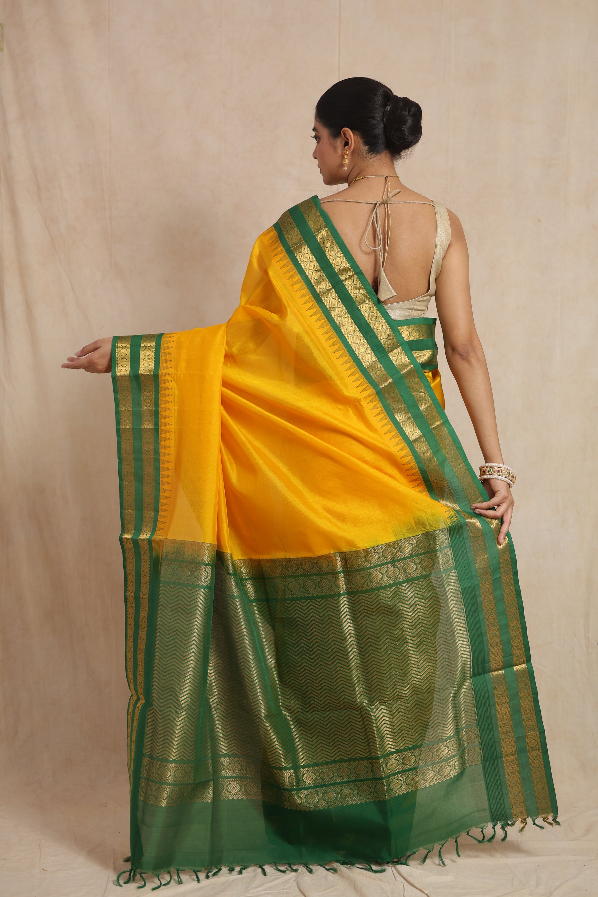 Back view of golden yellow Kanchipuram Sico saree with green zari border