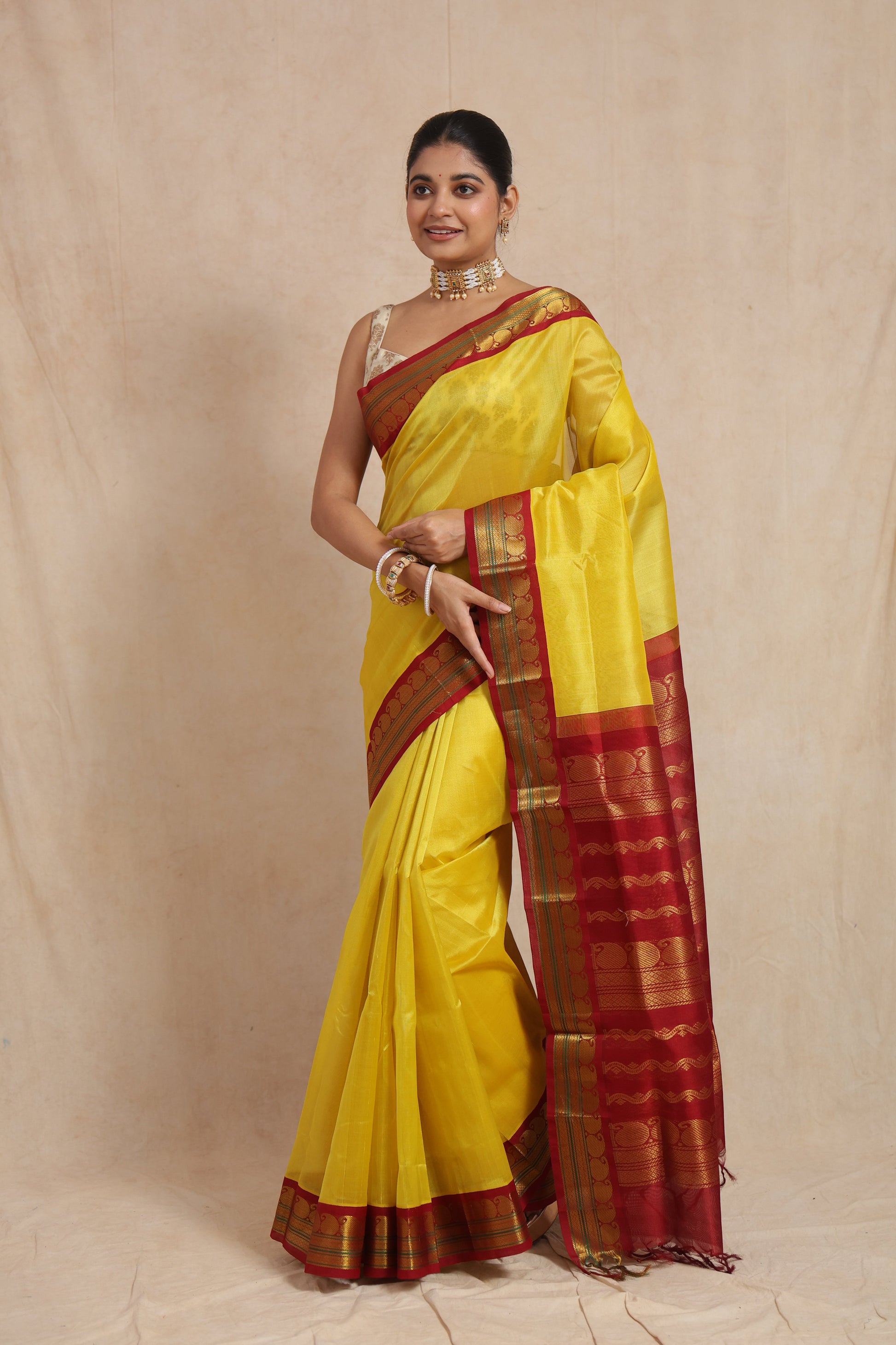 Full view of yellow Kanchipuram Sico saree with maroon zari border