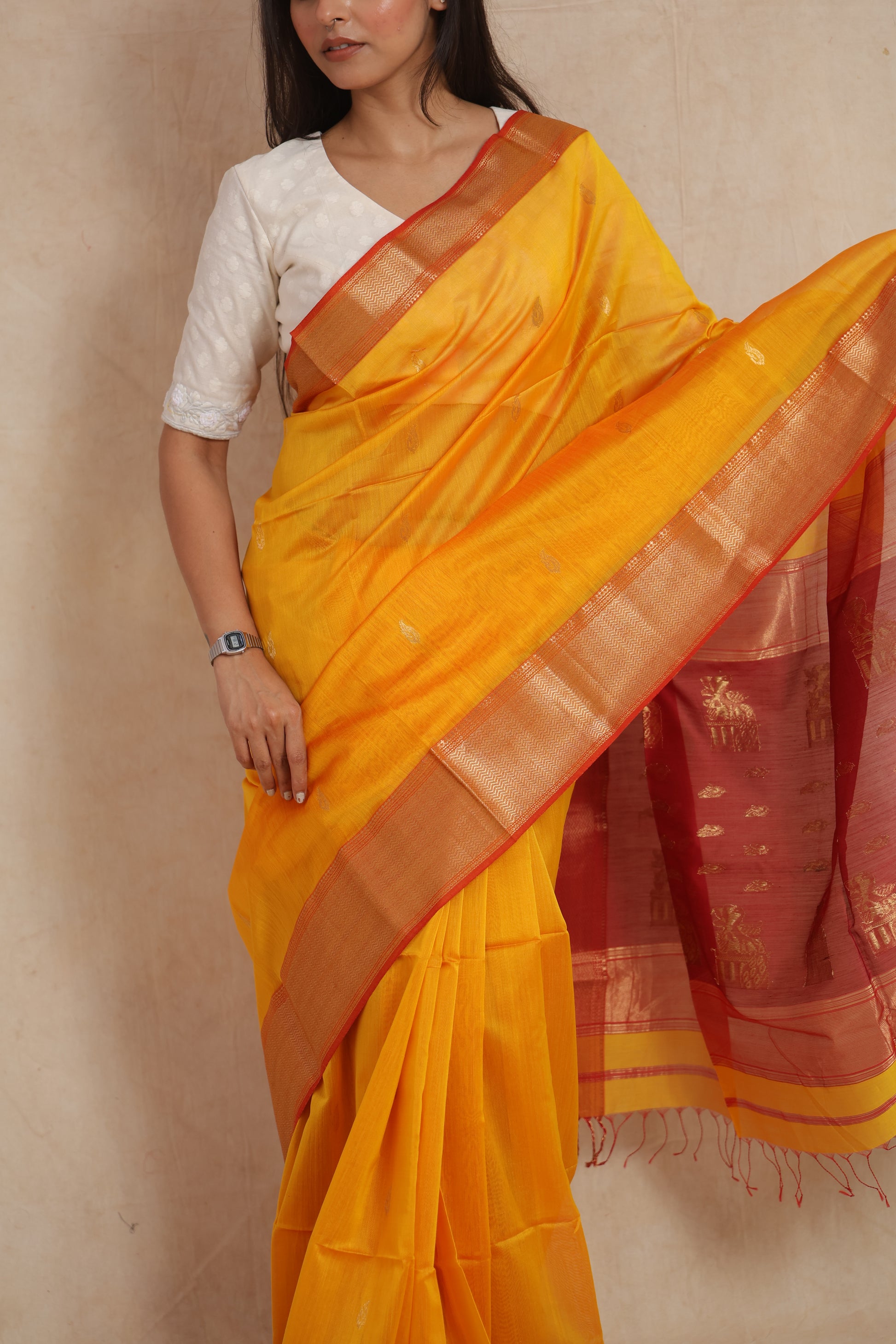 Detailed drape and golden border of yellow Maheshwari SICO saree
