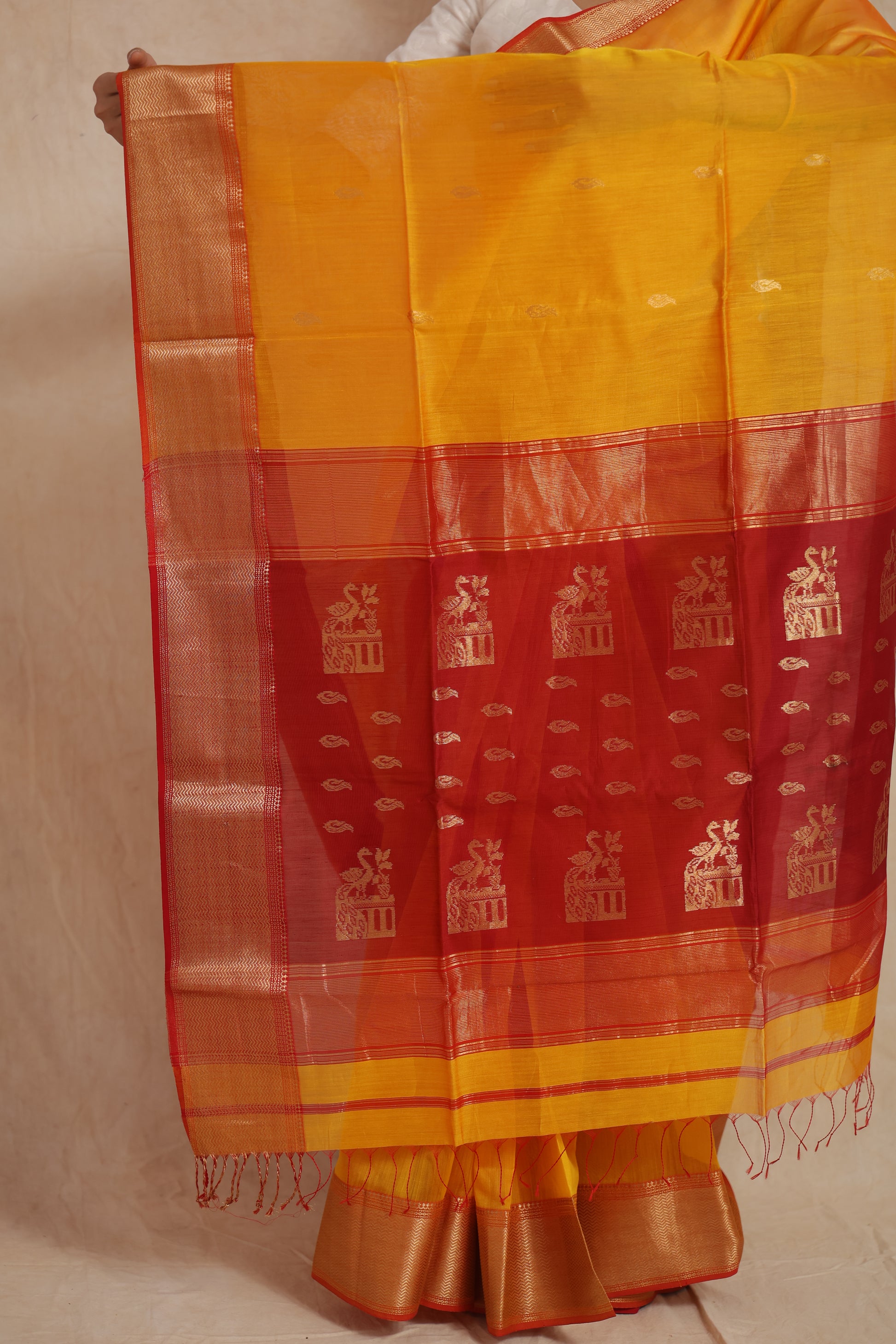 Close-up of red zari woven pallu on yellow Maheshwari SICO saree
