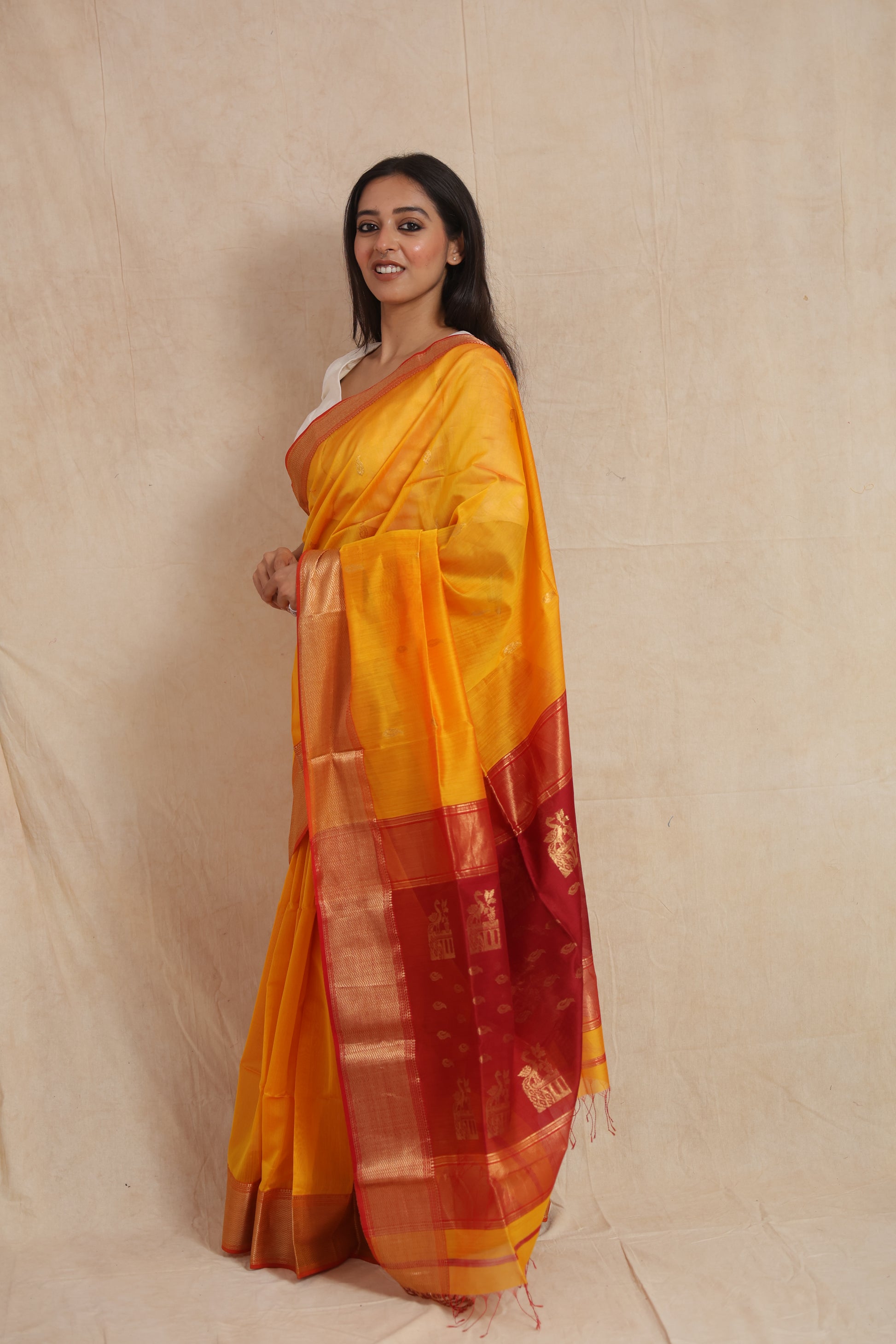 Side profile of yellow Maheshwari SICO saree with red pallu