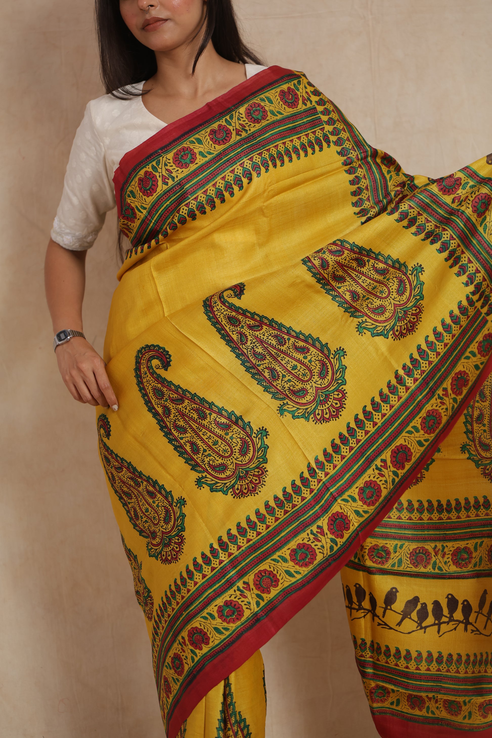Close-up of sunshine yellow printed Tussar saree with intricate floral border work
