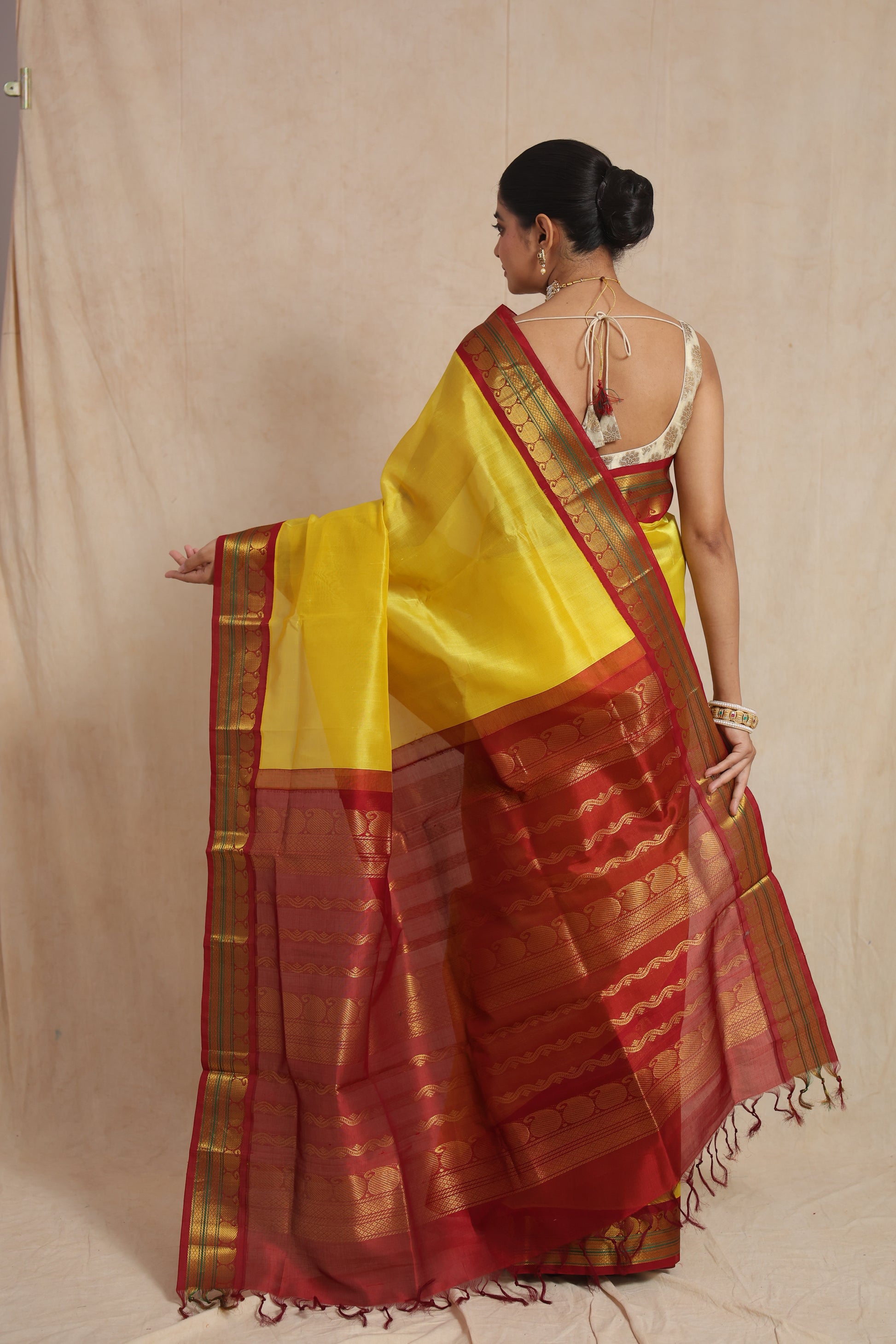 Back view of yellow Kanchipuram Sico saree with rich maroon pallu