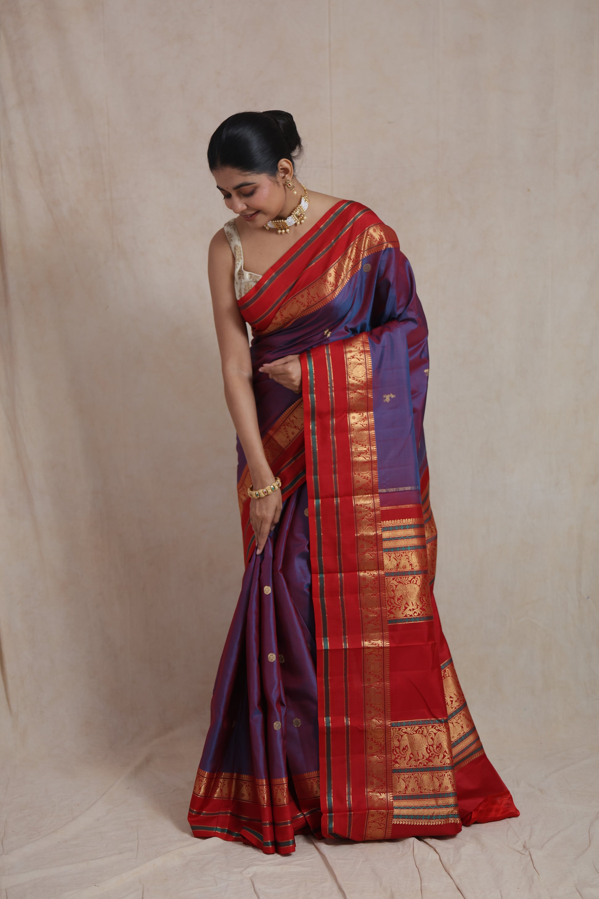 Detailed red zari woven border of royal violet Kanjivaram silk saree